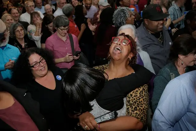 People celebrate as they watch election results at a watch party for Democratic congressional candidate Antonio Delgado in Kingston, N.Y